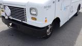 A white 2011 Ford Econoline with a distinctive front design featuring a rectangular grille and round headlights