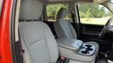 Interior view of a 2013 RAM 2500 showing two front seats with gray fabric upholstery and a center console featuring cup holders