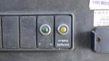 Control panel with two buttons labeled E D and a yellow and green indicator light along with a button labeled HYBRID SERVICE