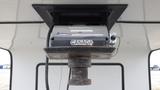 A fifth wheel hitch mounted on a ceiling panel with a label displaying Canada