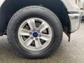 A close-up of a silver alloy wheel on a 2017 Ford F-150 showing the tire tread and Ford logo on the center cap