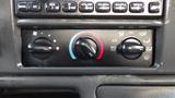 The image shows the climate control panel of a 2008 Ford F-650 featuring dials for fan speed air conditioning and temperature adjustment