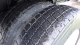 The image shows the worn tires of a 2008 Ford F-650 highlighting the tread pattern and surface condition of the rubber