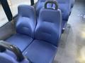 Two blue fabric seats with textured surfaces and comfortable backrests in a vehicle interior