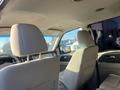 Interior view of a 2013 Ford Expedition showing beige leather seats and a modern dashboard with steering wheel