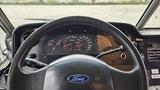 Steering wheel and dashboard of a 2006 Ford Econoline with various gauges and controls visible