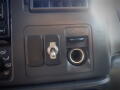 Close-up of the dashboard of a 2007 Ford F-650 featuring a toggle switch and a power outlet