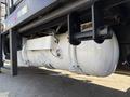 A large white fuel tank mounted underneath a 2016 Ford F-350 SD truck with visible mounting brackets and connectors