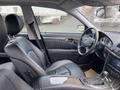 The interior of a 2007 Mercedes-Benz E-Class featuring black leather seats and a modern dashboard design with a steering wheel and infotainment system