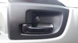 Close-up of a black door handle on a 2016 Hino 195 truck interior