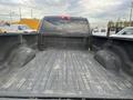 View of the empty bed of a 2010 Dodge Ram truck showing the interior surface with ridges and raised areas on either side