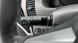 Close-up of the steering column controls in a 2016 Nissan Frontier showing the headlight and turn signal stalk