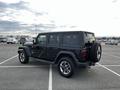 A black 2019 Jeep Wrangler parked in a lot showcasing its rugged design and off-road capabilities