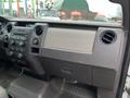 Interior dashboard of a 2010 Ford F-150 featuring controls and air vents with a beige section across the middle