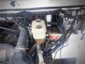 2003 Freightliner MT45 Chassis engine compartment featuring various hoses wires and components including a coolant reservoir and a brake fluid container