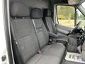 A 2017 Mercedes-Benz Sprinter with three upholstered front seats in gray fabric