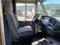 Interior view of a 2011 Ford Econoline showing the driver's seat and dashboard with controls and gauges