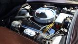 The engine compartment of a 1971 Chevrolet Corvette Stingray featuring a chrome air filter and various automotive components