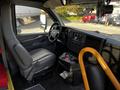 Interior view of a 2015 Chevrolet Express showing the driver's seat dashboard and control panel