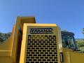 A yellow TerraMac RT7R with a prominent logo on the side and a visible grille pattern