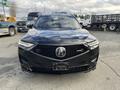 A black 2023 Acura MDX with a prominent front grille and sharp LED headlights facing forward