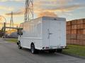 A white 2017 Freightliner M Line box truck is parked facing away with a rear door and a large cargo area designed for transporting goods