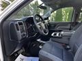 Interior view of a 2017 GMC Sierra 1500 featuring a modern dashboard with control panel and a spacious center console in a driver-focused layout