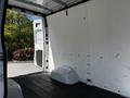 A 2022 Mercedes-Benz Sprinter van with an open rear door revealing an empty cargo area with a clean white interior and a flat floor