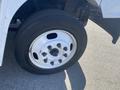 A close-up of the front wheel of a 2007 Freightliner MT55 featuring a white wheel rim with multiple lug nut holes and a black tire