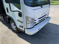 A white 2015 Isuzu NPR truck with a prominent front view showcasing the grille headlights and bumper