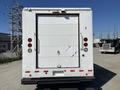 White 2011 Ford Econoline rear view with a large cargo door and red brake lights