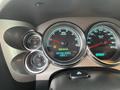 The dashboard of a 2013 Chevrolet Silverado Hybrid displaying RPM gauge speedometer and engine hours readout