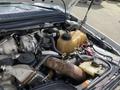 Engine compartment of a 2010 Ford F-550 showing various components including the engine block hoses and a coolant reservoir