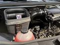 A 2019 Mercedes-Benz Sprinter engine compartment displaying an open coolant reservoir and air filter housing with a warning label against the use of certain fluids