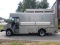 A 2007 Morgan Olson Workhorse W42 delivery truck with a silver exterior featuring a flat roof and side compartments for storage
