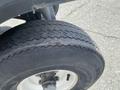 Close-up of a worn tire on a 1999 Ez-go Industrial showing tread pattern and rim details