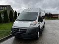 A 2016 RAM Promaster van with a white exterior and a black grille parked on an asphalt surface