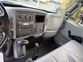 Interior view of a 2007 International 4200 featuring a dashboard with controls a stereo system and a gear shift