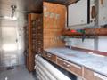 Interior of a 2007 Morgan Olson Workhorse W42 featuring wooden cabinets a countertop and various tools and supplies on a workbench