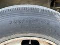 Close-up of a tire from a 2010 Freightliner MT45 Garbage Truck showing the size 22570R19.5 and load range specifications