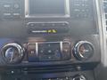 Interior dashboard controls of a 2017 Ford F-150 featuring buttons for audio and climate control along with a display screen