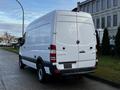 A white 2017 Mercedes-Benz Sprinter van with a high roof and a side loading door parked on a street