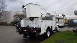 A 2005 International 4300 truck equipped with a large aerial lift and a storage compartment in the rear