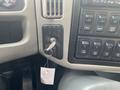 A key is inserted into the ignition of a 2016 International 7400 with various control buttons adjacent to it