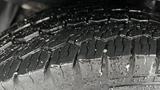 Close-up of a wet tire tread on a 2012 Ford Transit showing deep grooves and water droplets on the surface