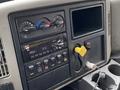 Dashboard of a 2018 International 26 Foot Cube with air brake controls a radio and various switches for vehicle functions