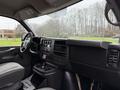 Interior of a 2009 Chevrolet Express showing the dashboard seating area and control features