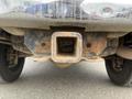 A rusted trailer hitch attached to the rear of a 2010 Dodge Ram truck