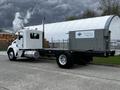 A white 2014 Kenworth T370 truck with a flatbed chassis and streamlined design parked on a pavement with a visible exhaust stack