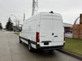 A white 2019 Mercedes-Benz Sprinter van parked on the street with a high roof and cargo area visible at the rear